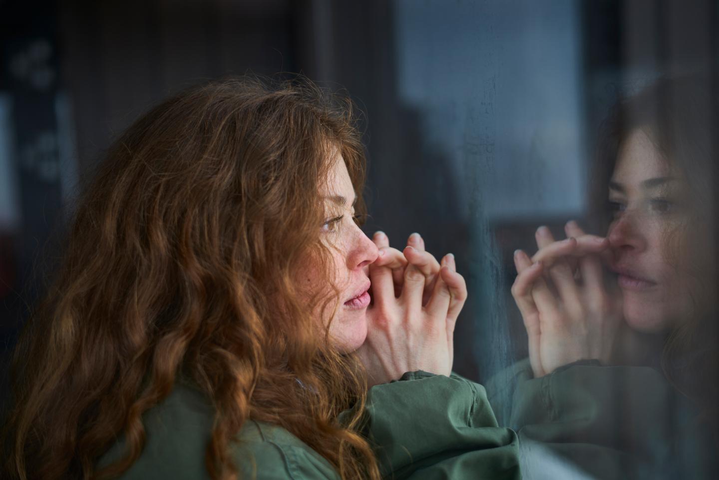 Woman looking out window
