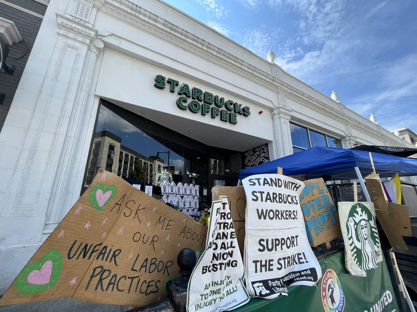 The exterior of the striking Starbucks location, with hand-written signs hanging outside.