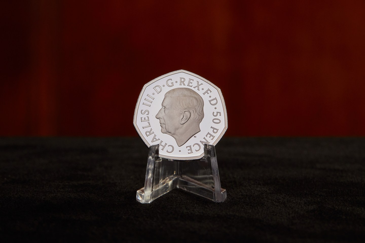 A 50 pence coin bearing the portrait of King Charles III.