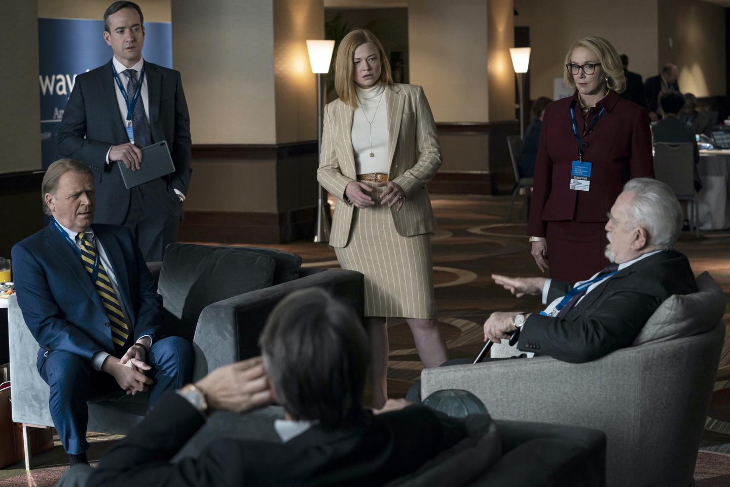 Members of the fictional Roy family and board members gather in a scene from Succession