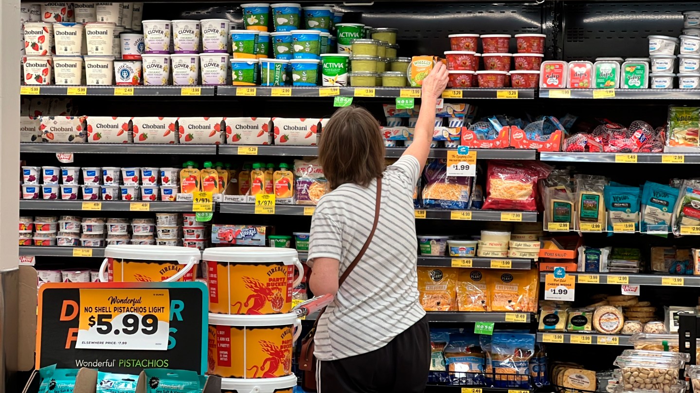 A customer looks at refrigerated items at a Grocery Outlet store in Pleasanton, Calif. on Sept. 15, 2022.  