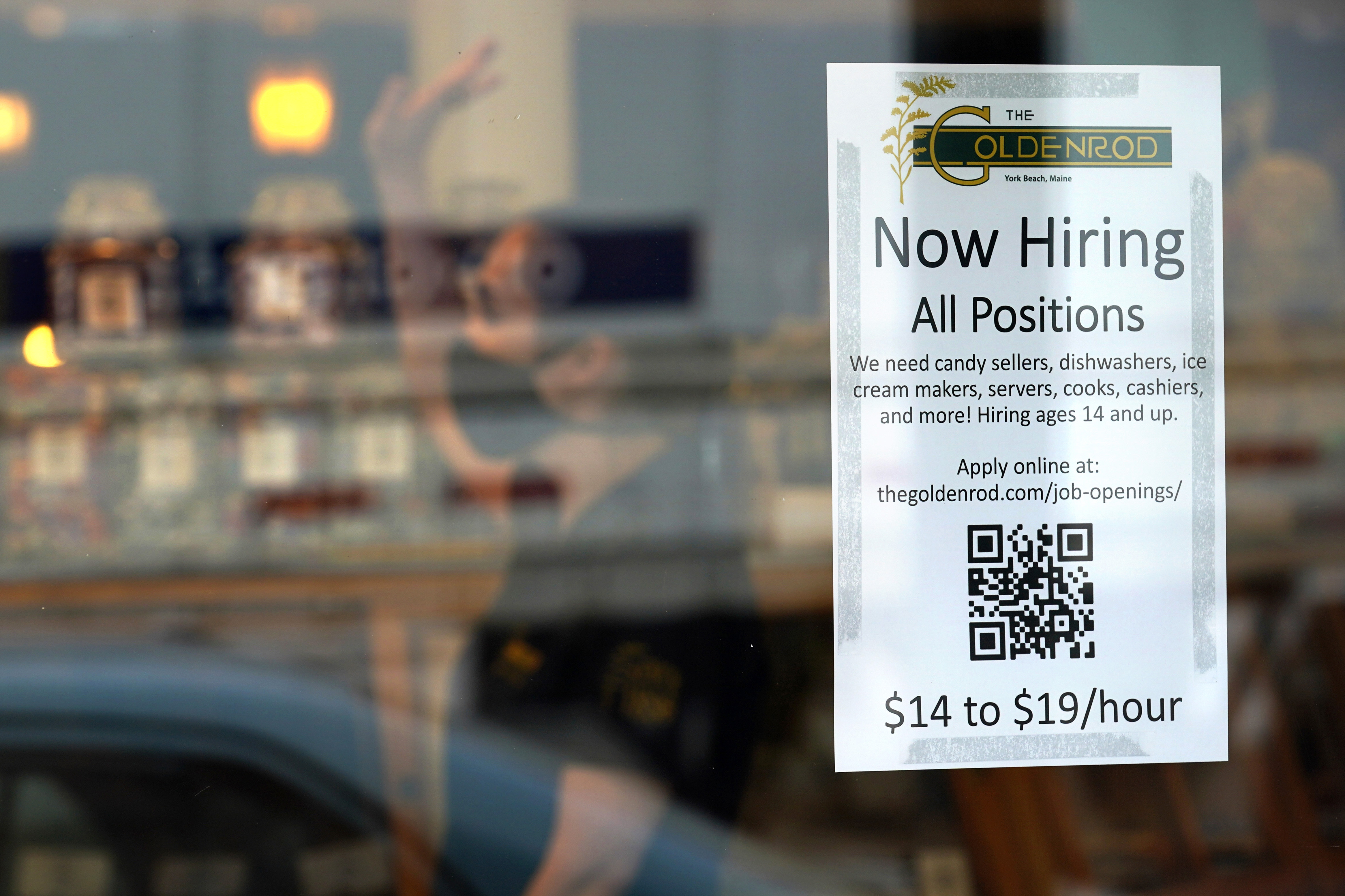 A sign advertises for help The Goldenrod, a popular restaurant and candy shop, June 1, 2022, in York Beach, Maine.  