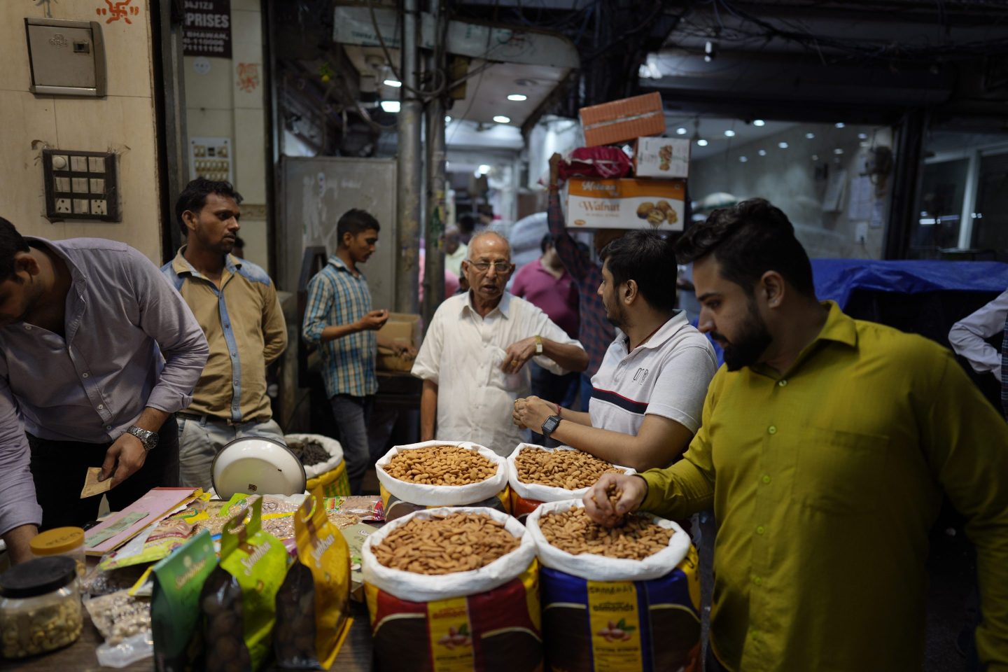 Small retailers shop for dry fruits in a wholesale market, in New Delhi, Oct. 10, 2022. A record drop in the rupee -- on top of higher raw material and shipping costs - has made the nuts much costlier for Indian consumers.