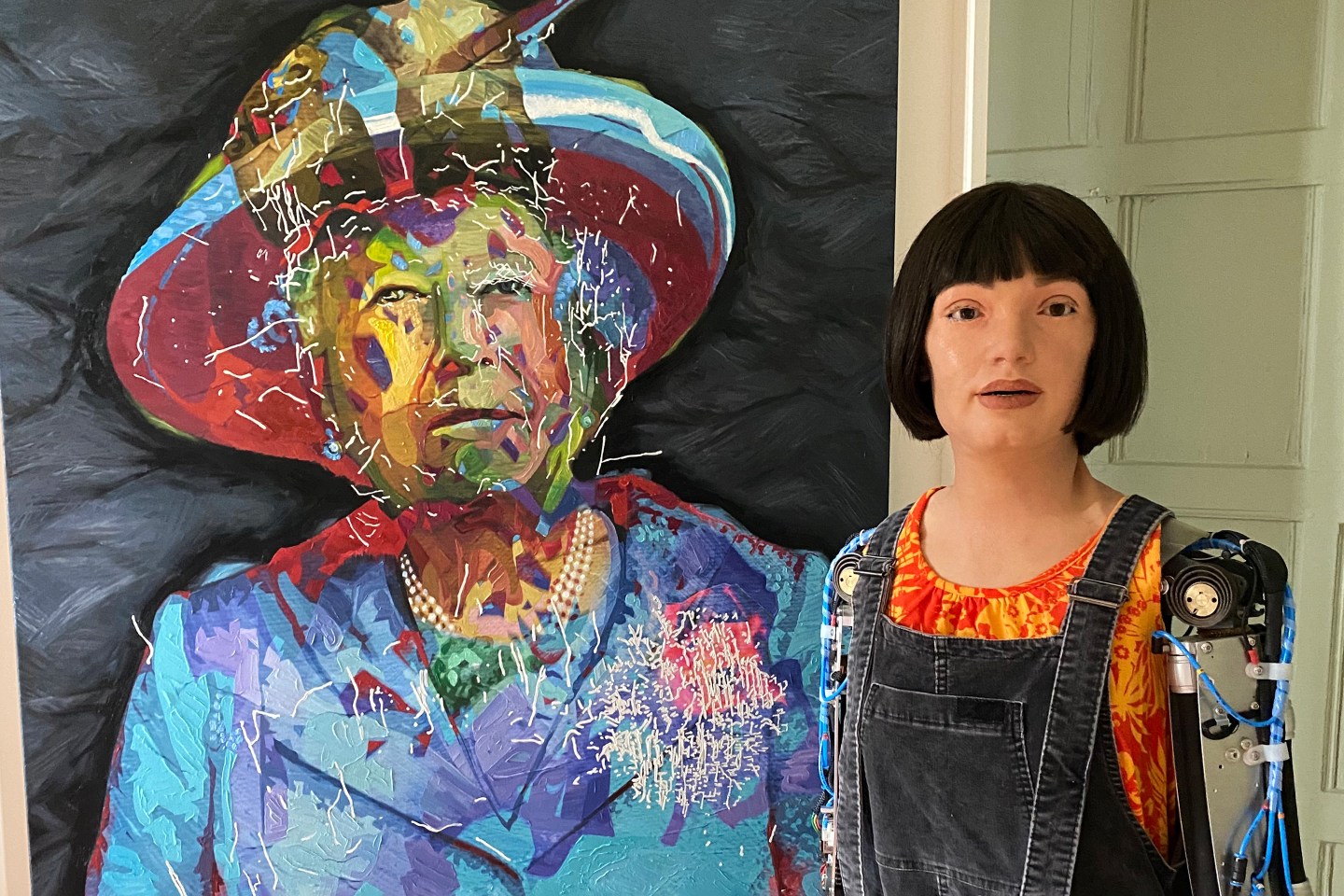 Ai-Da with the 'Algorithm Queen' painting