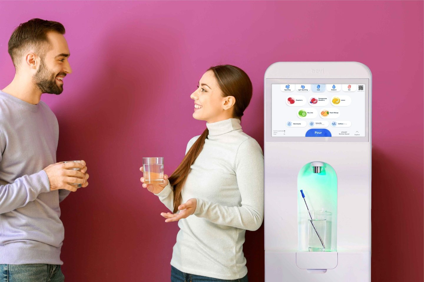 Two coworkers face each other as one leans on a Bevi sparkling water machine