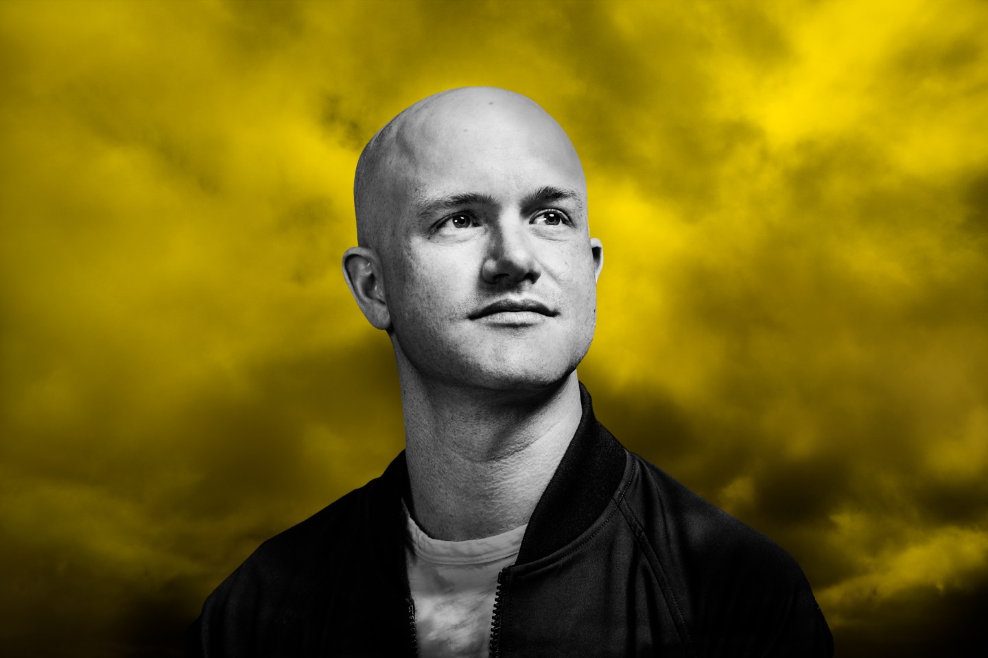 Coinbase CEO Brian Armstrong in front of dark and stormy clouds.