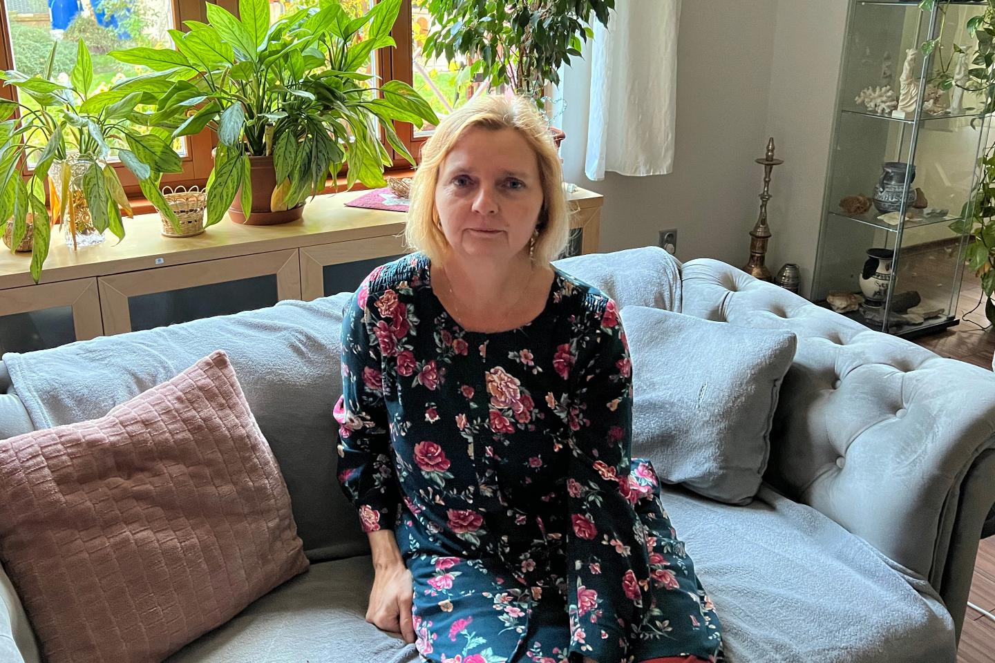 Pavla Picková sitting on the couch in her living room.