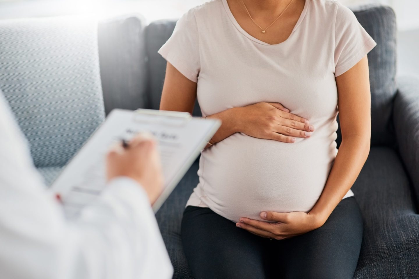 pregnant woman talking to a doctor