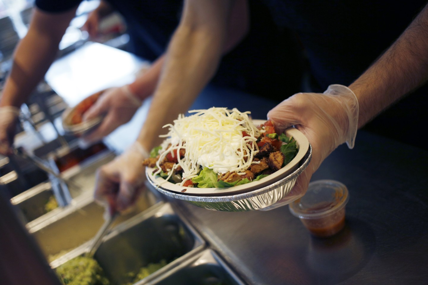 An employee prepares a burrito bowl at a Chipotle Mexican Grill Inc. restaurant