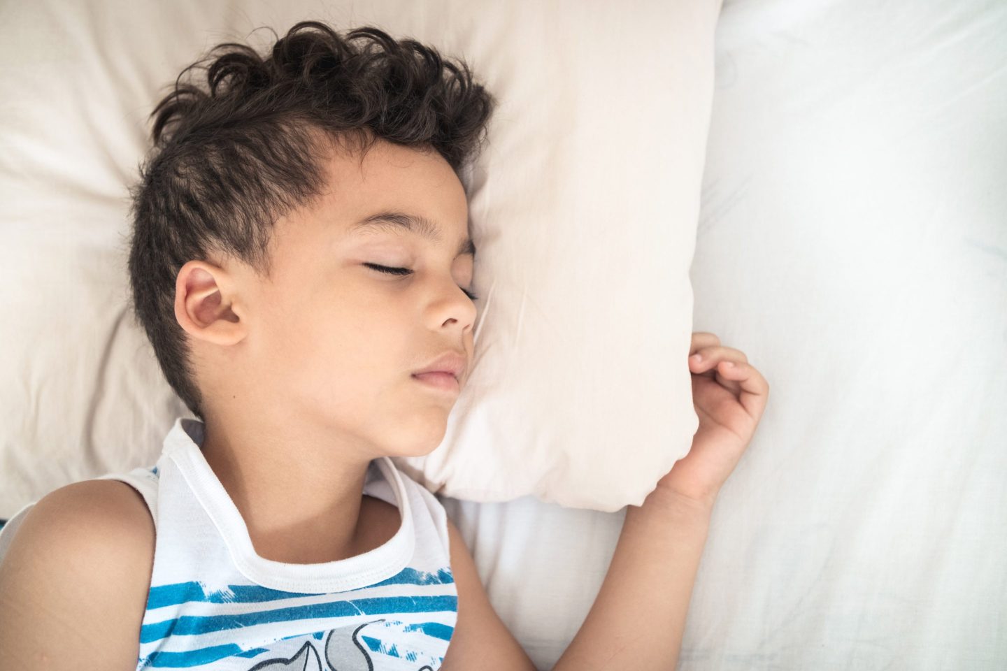 Young boy sleeping in a bed