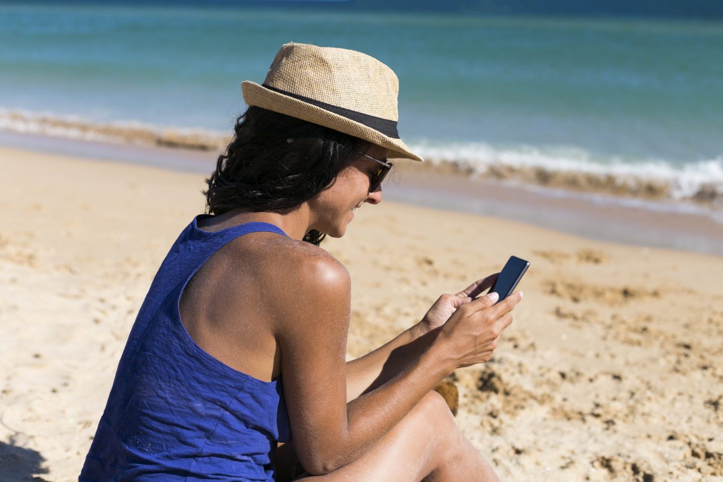 Woman on her phone on the beach