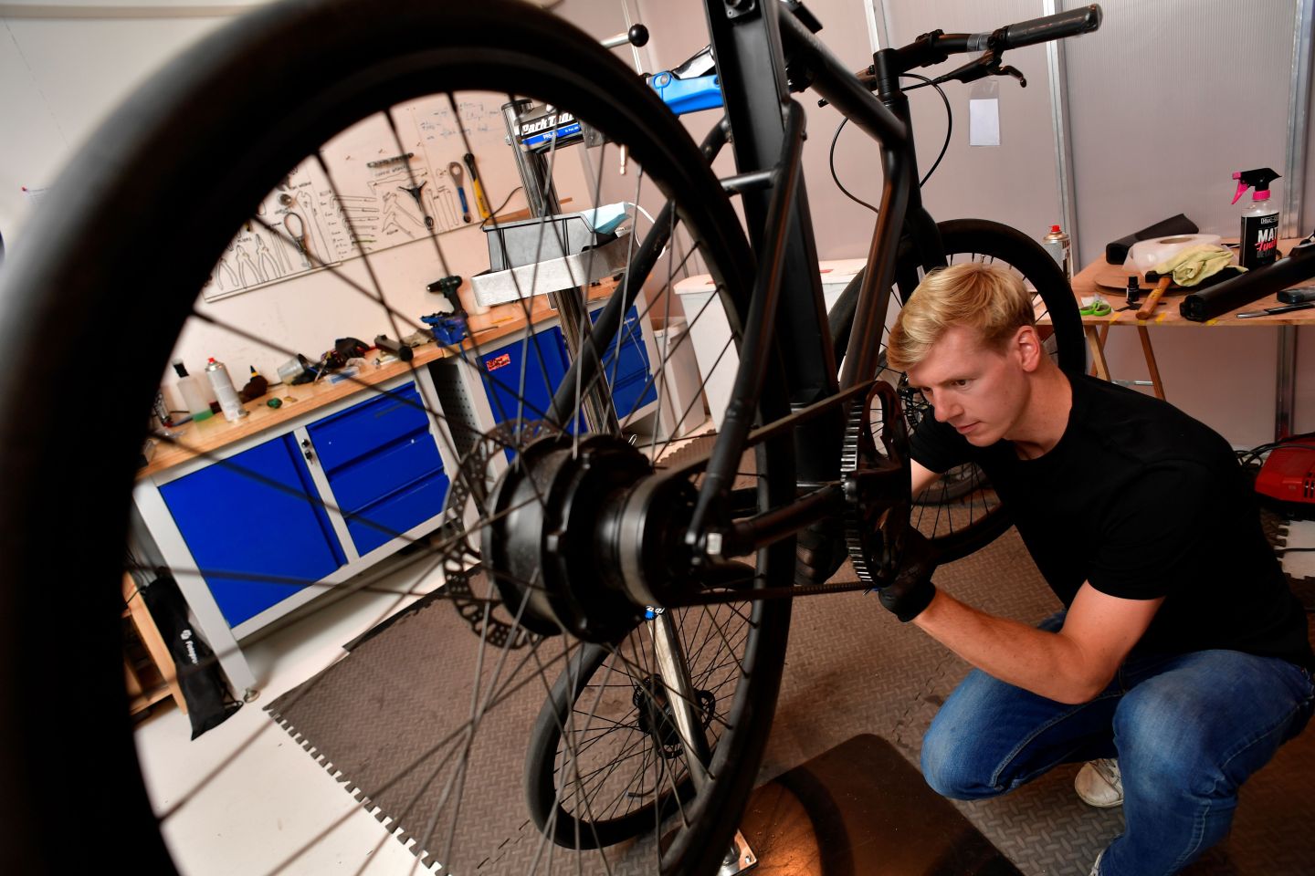 A mechanic works on a Cowboy e-bike.