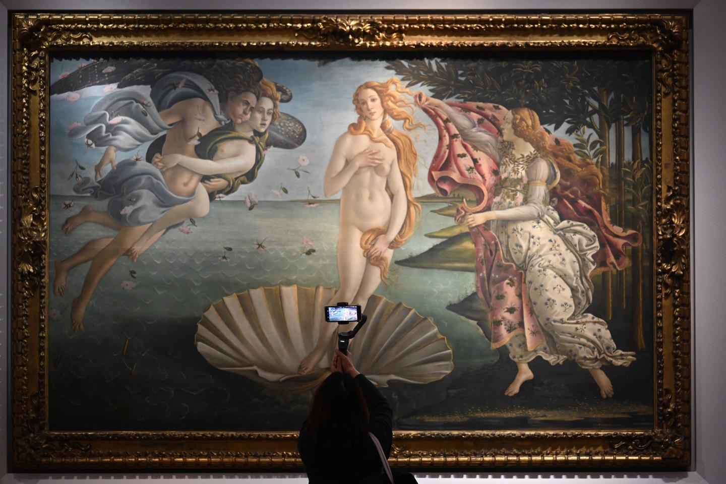 A visitor takes a video with her smartphone of Sandro Botticelli's "The Birth of Venus" on January 21, 2021 at the Uffizi Galleries in Florence, Tuscany.