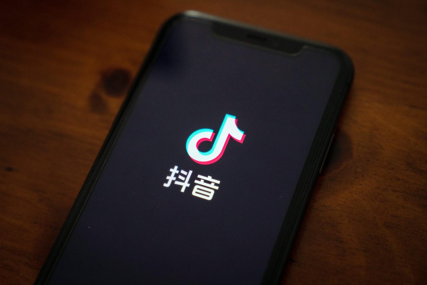 The Douyin logo on a smartphone