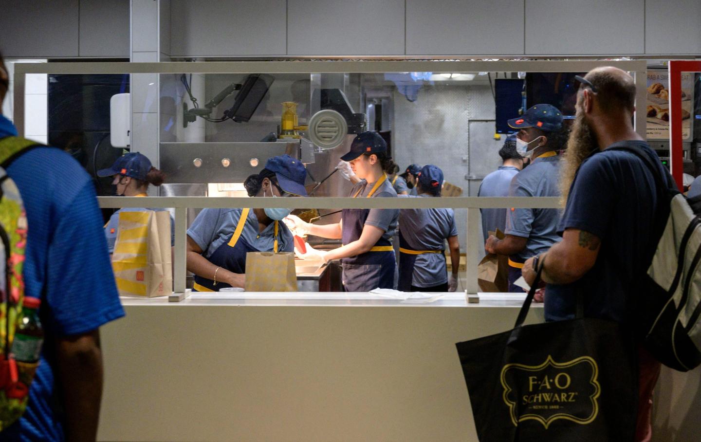 Employees prepare a customer’s order at a McDonald’s restaurant in New York