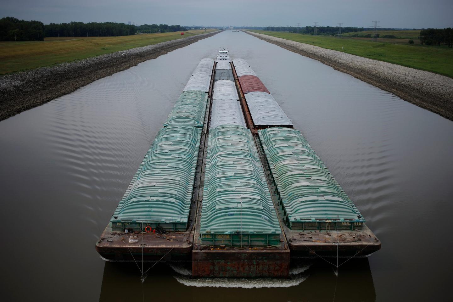 A towboat pushes barges up the Mississippi River in Granite City, Illinois