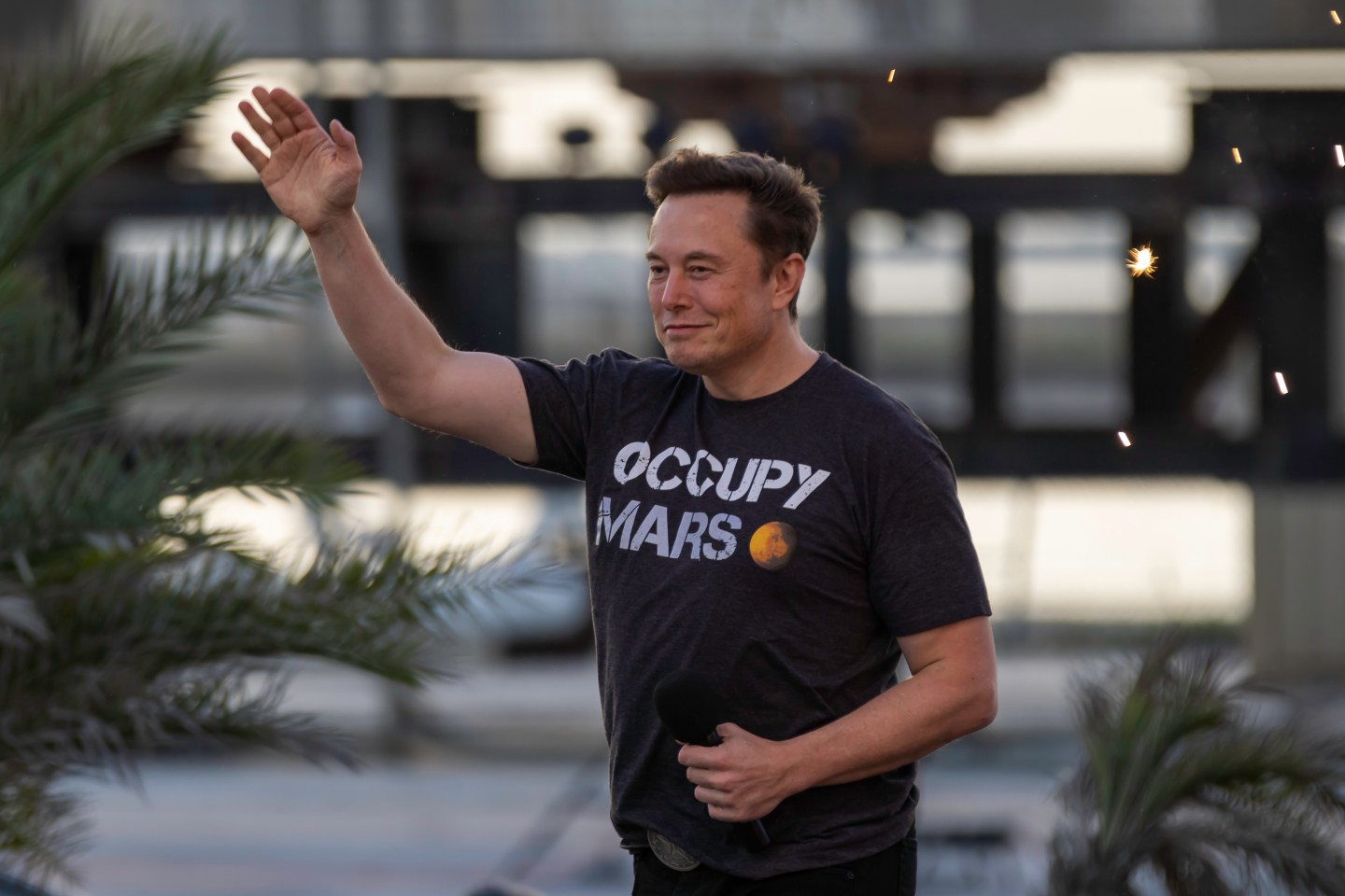Shot of Elon Musk waving to a crowd at a SpaceX event