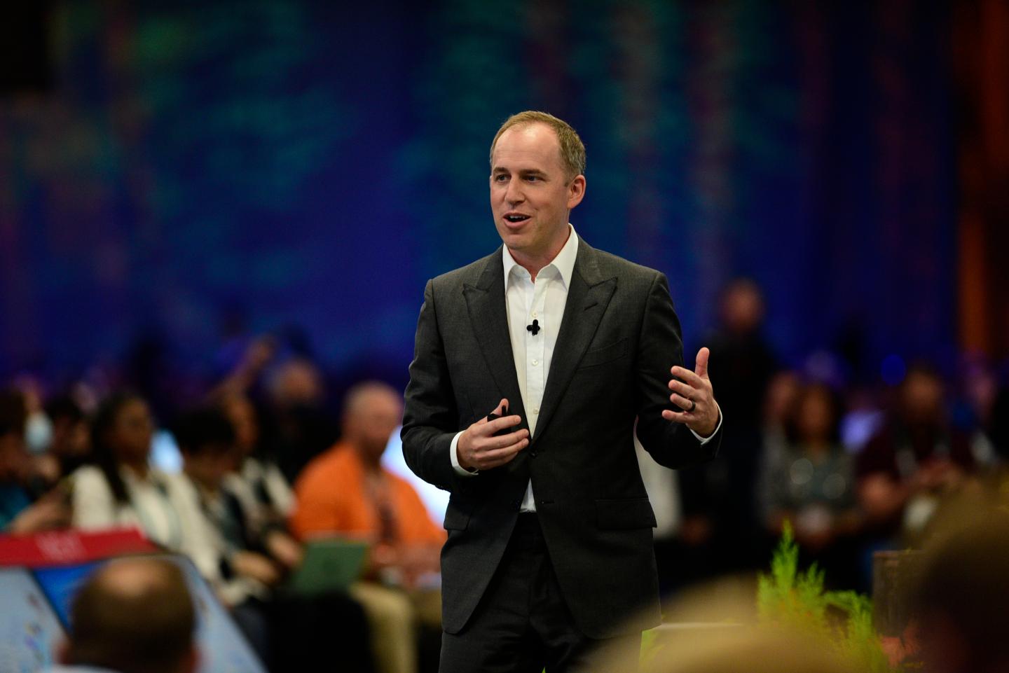 Bret Taylor speaking on stage at a conference.