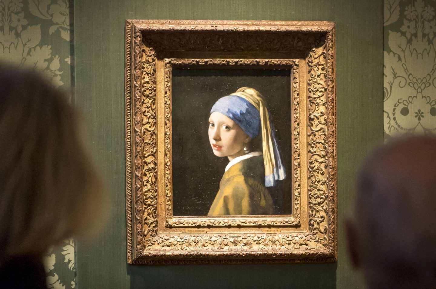 Visitors looks at the Johannes Vermeer's painting "Girl with a Pearl Earring"