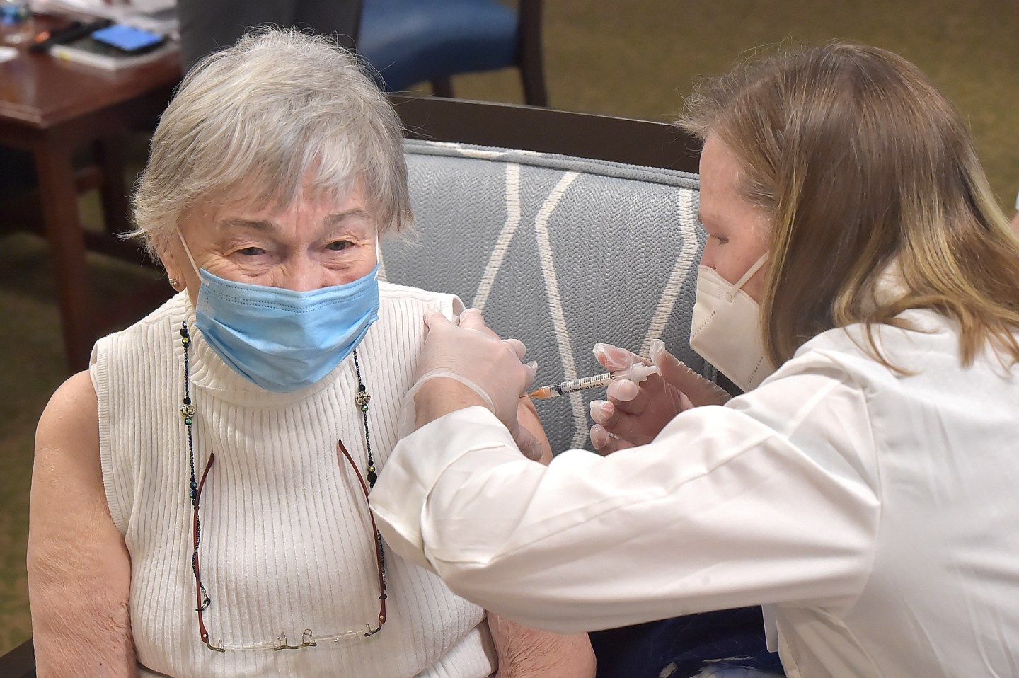 An elderly woman getting a COVID vaccine