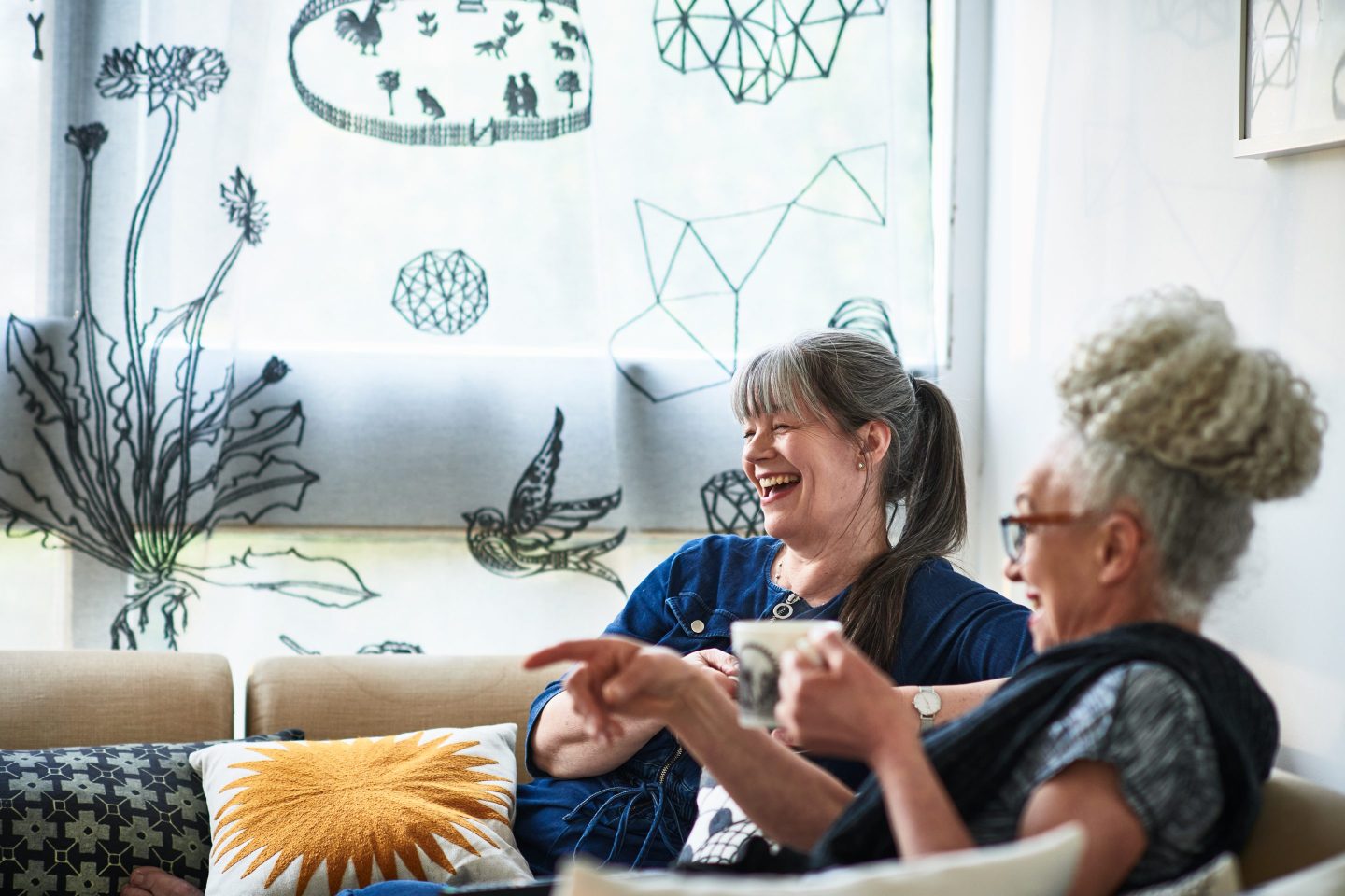 Two women having coffee break at home