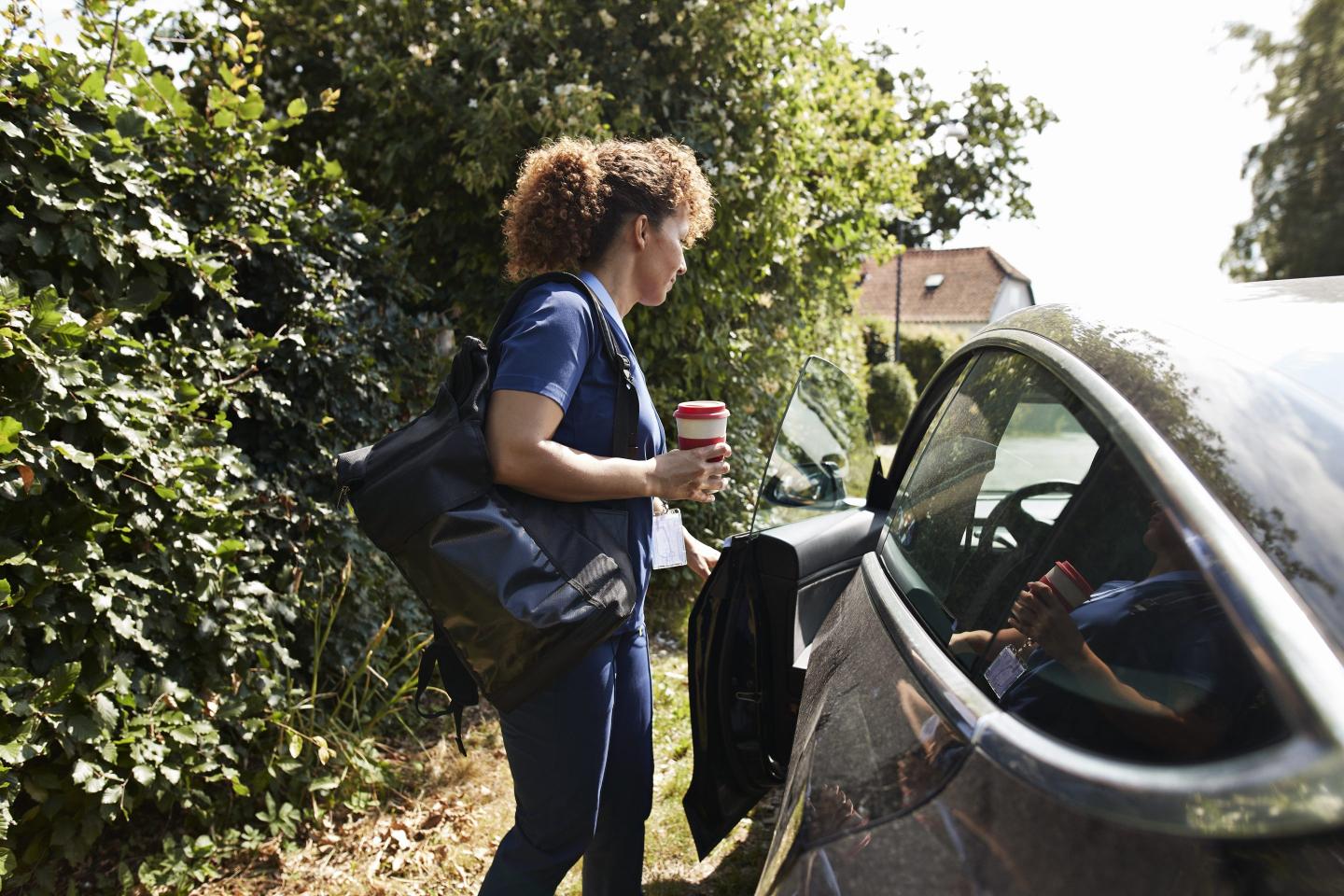 woman entering her car for work