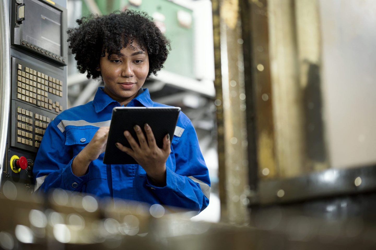 Employee uses a tablet on a production line