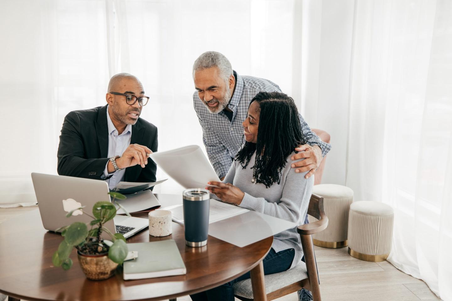 couple reviews paperwork with a financial advisor