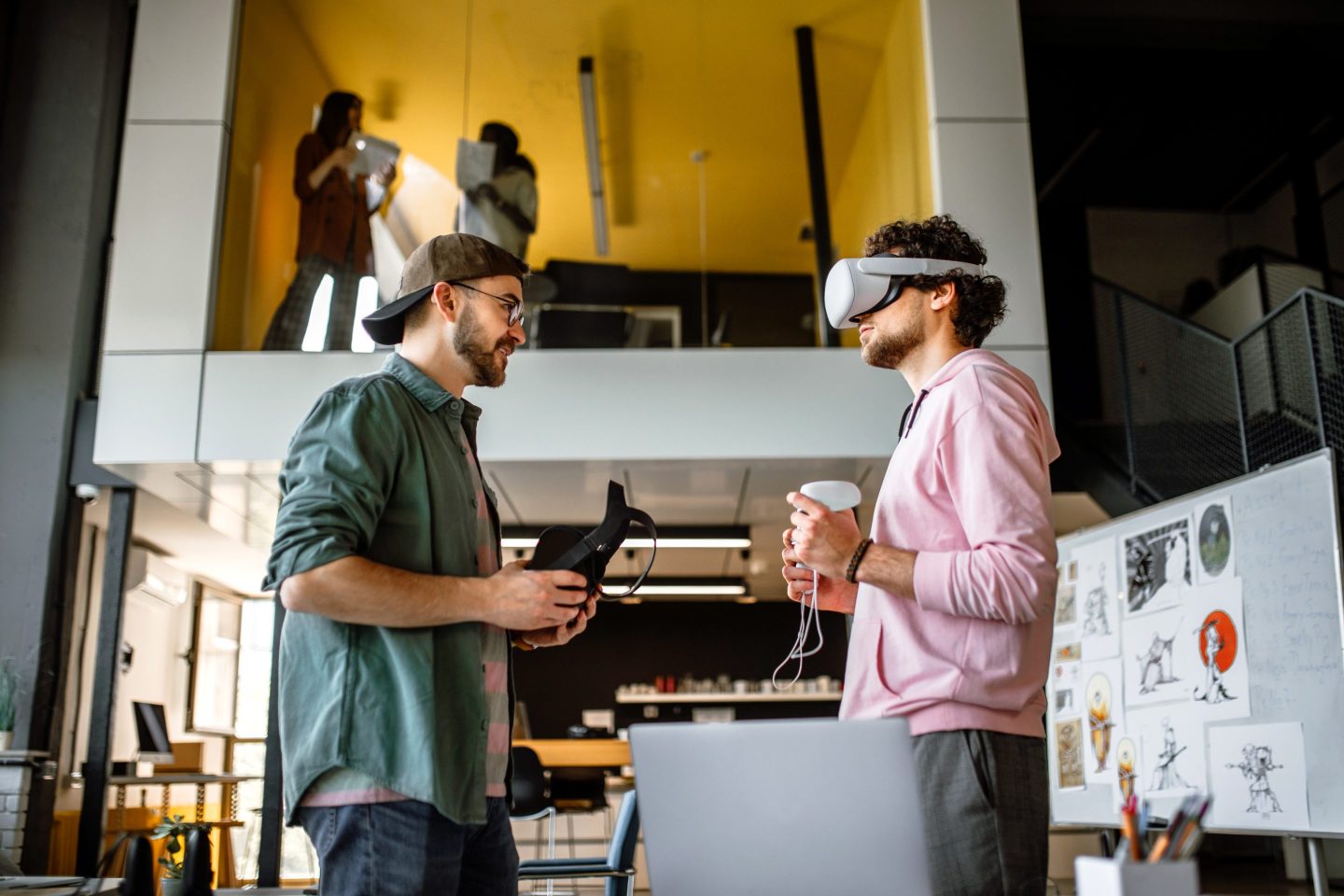 Group of coworkers testing VR simulator in the office