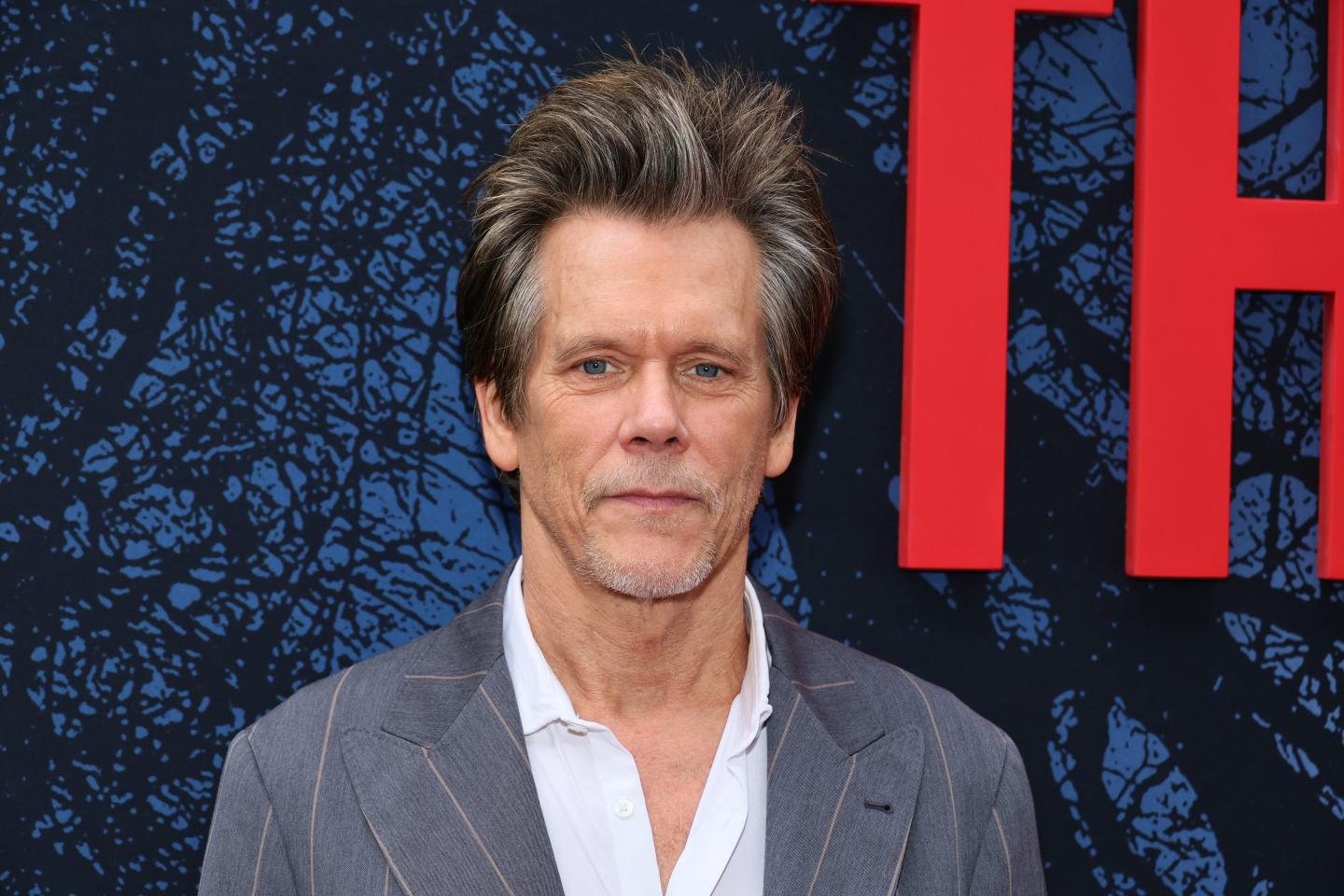 Actor Kevin Bacon poses at a premiere