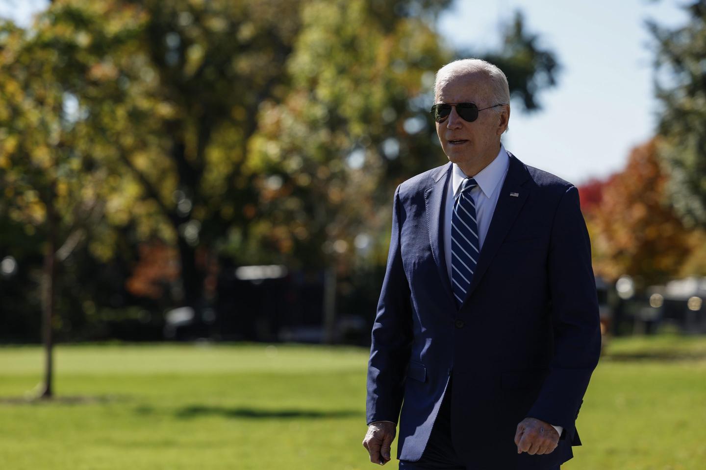 President Joe Biden walks to speak with members of the press