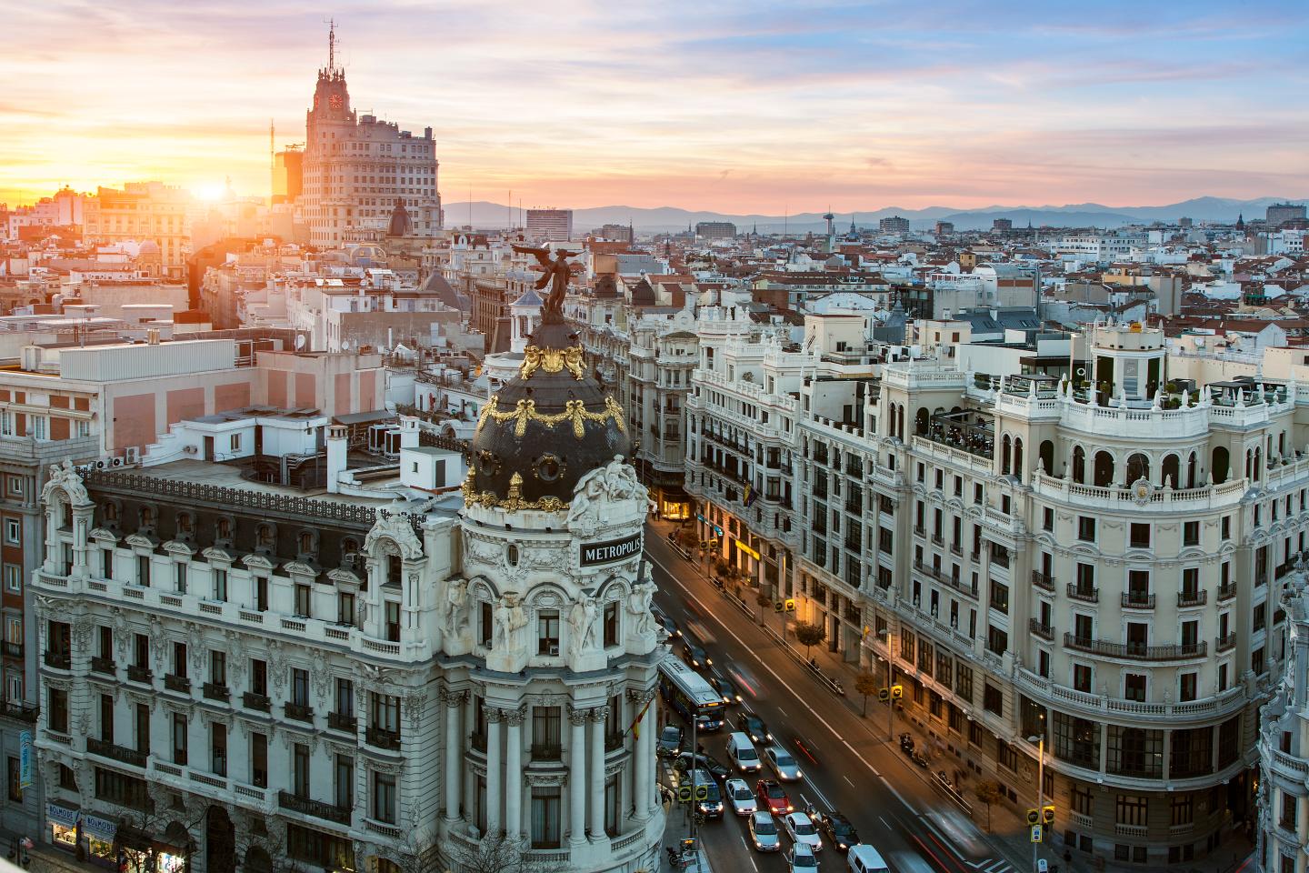 The sun rises over buildings in Europe.