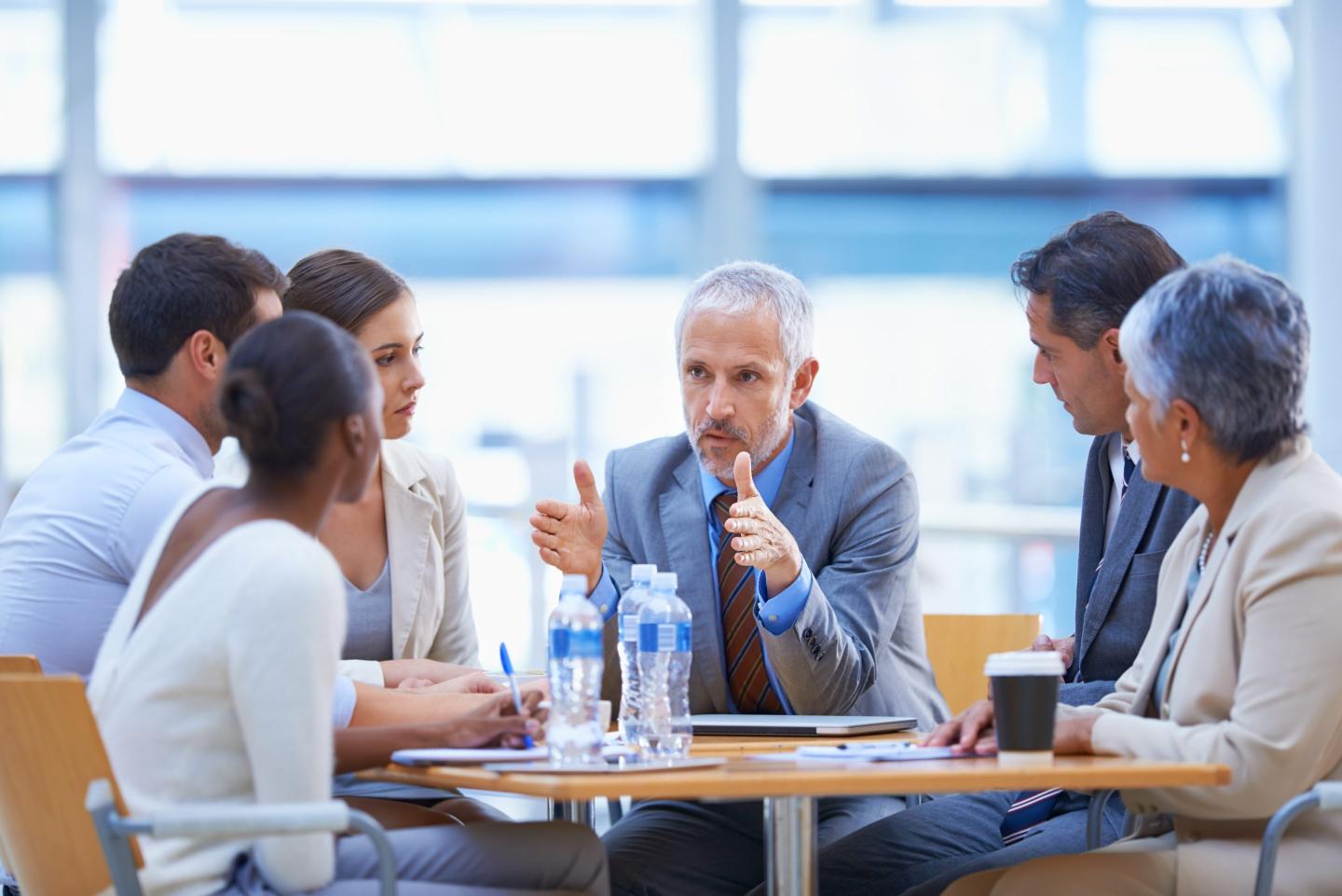 A businessperson shares ideas with colleagues