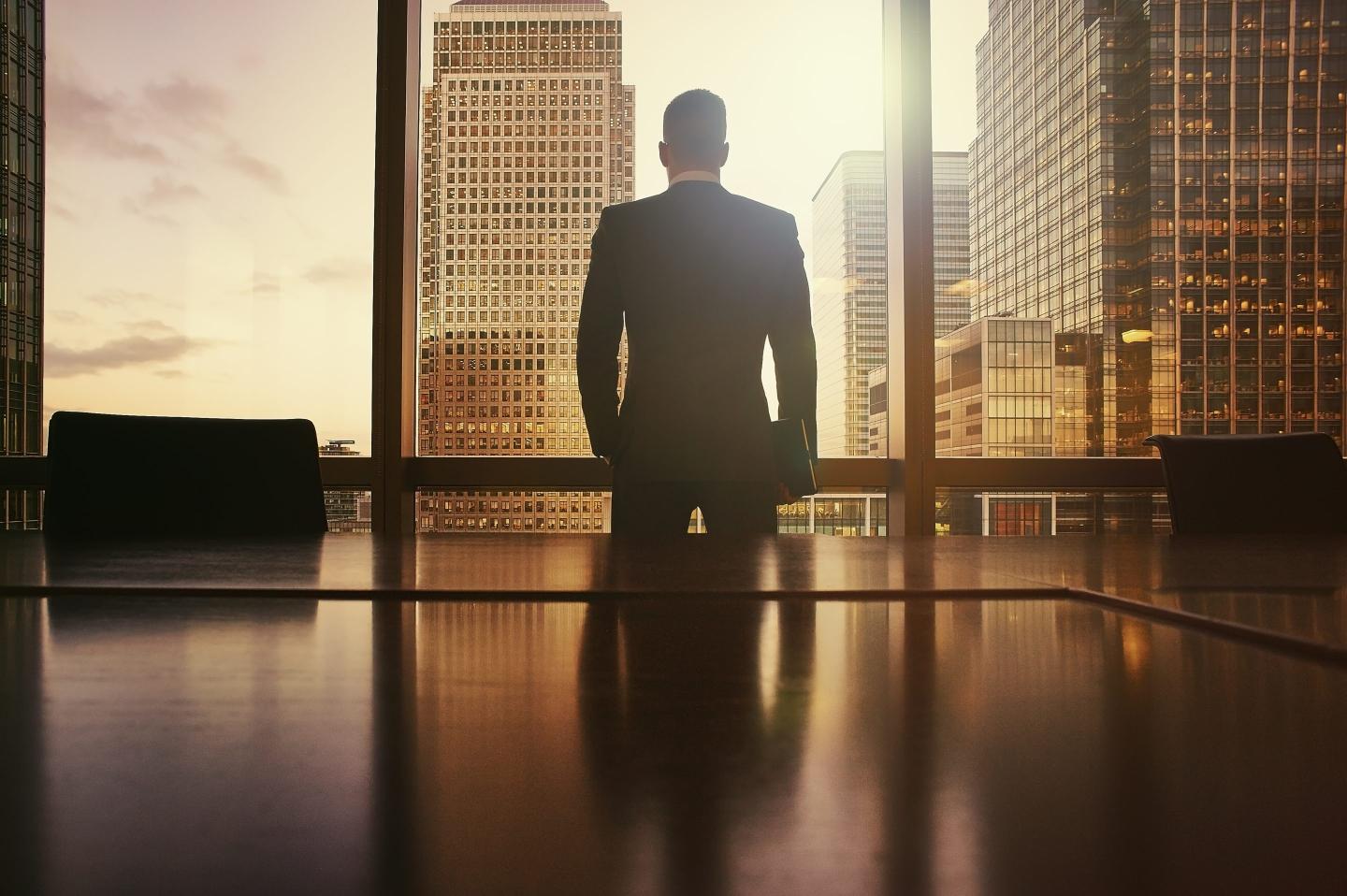 Businessman looking out at financial district