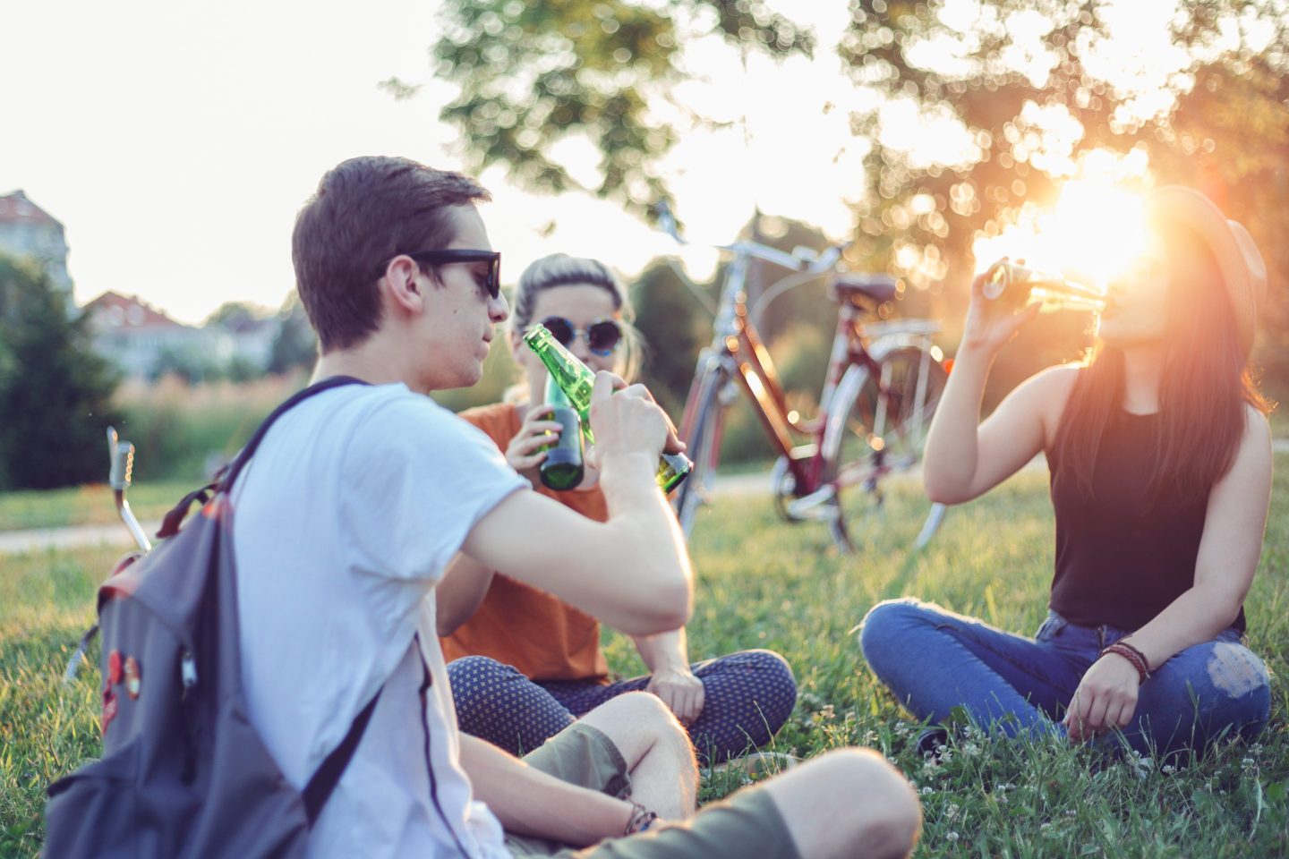 Teens drinking beer at sunset