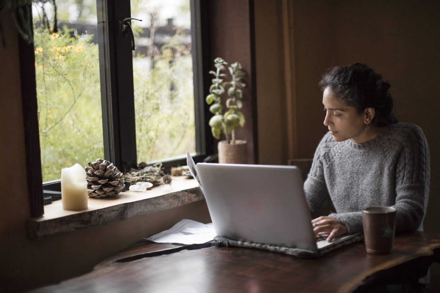 Woman working remotely on laptop at home