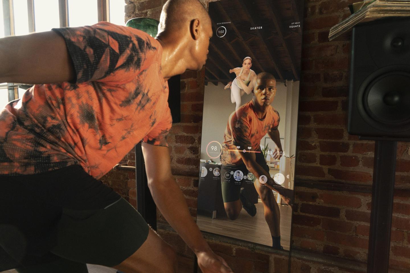 Man working out using an at-home fitness mirror