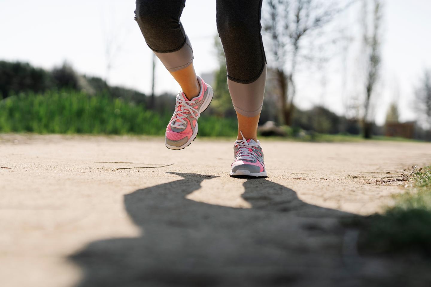 Legs of a woman running in a city park