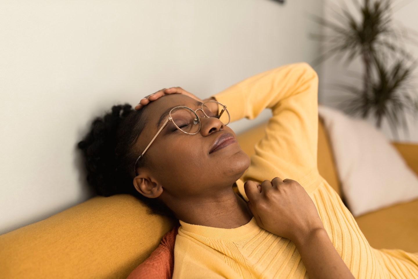 Portrait of an African American woman resting on the sofa.