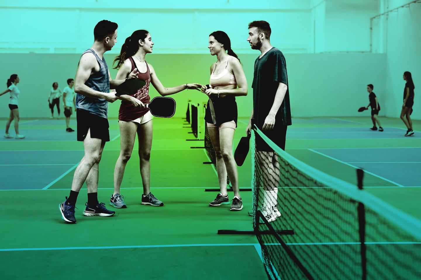 people shaking hands on pickleball court