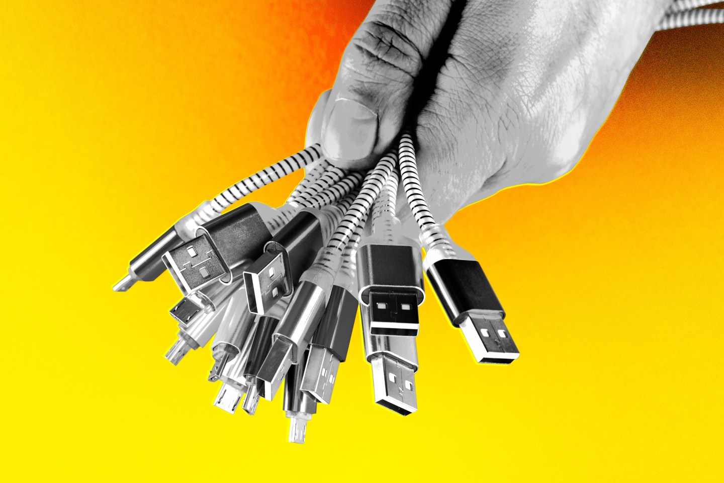 hand holding an array of phone and other electronic chargers