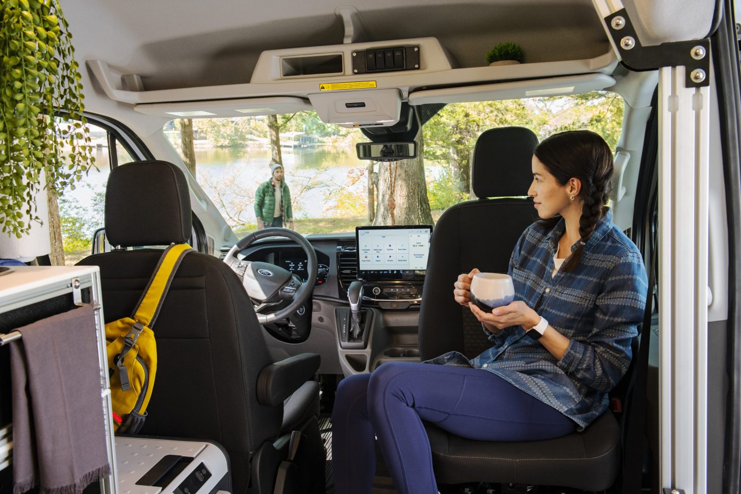 A woman in a RV holding a mug