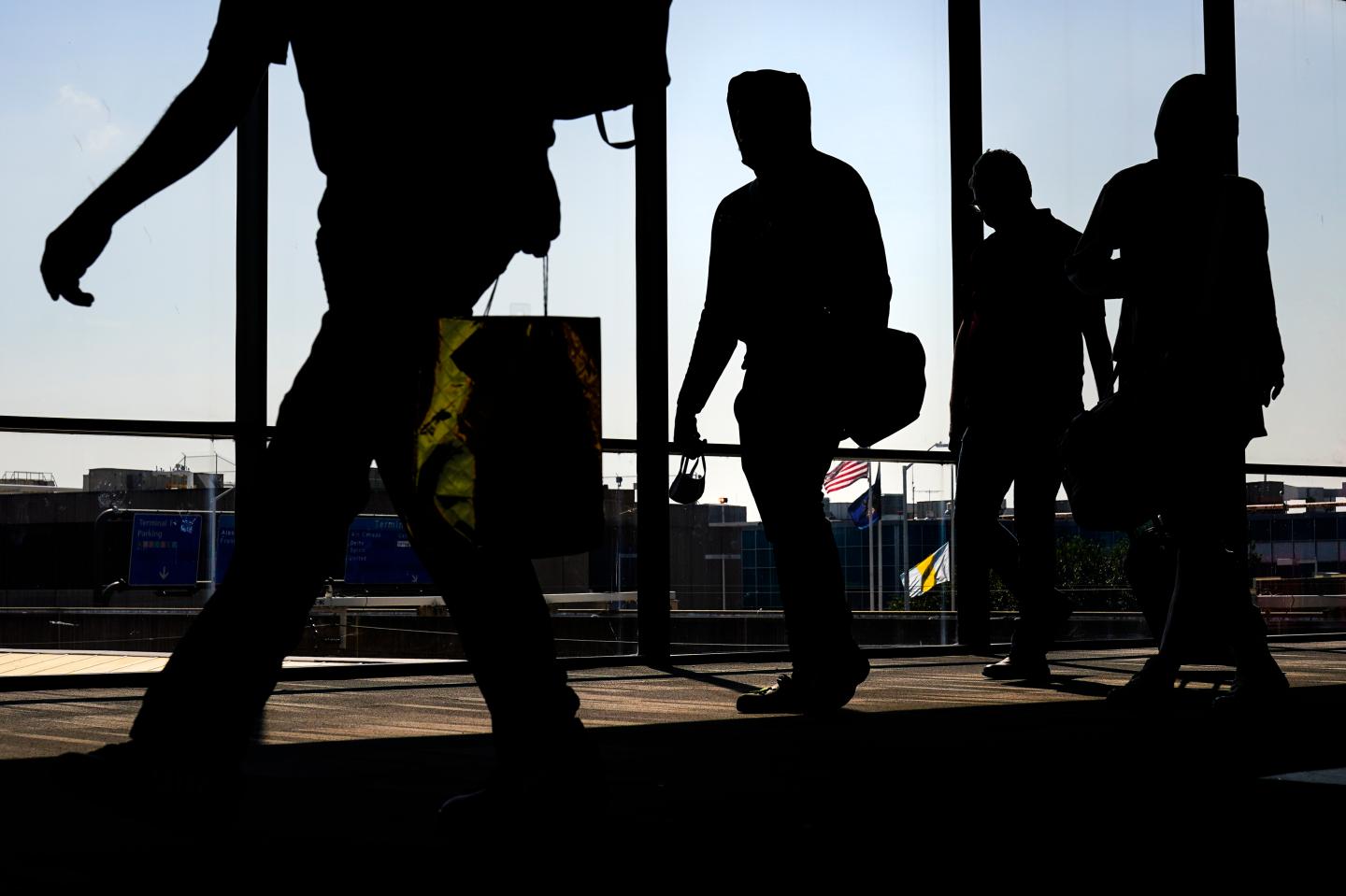 Arriving passengers move toward the baggage claim area at Philadelphia International Airport in Philadelphia on July 1, 2022. 