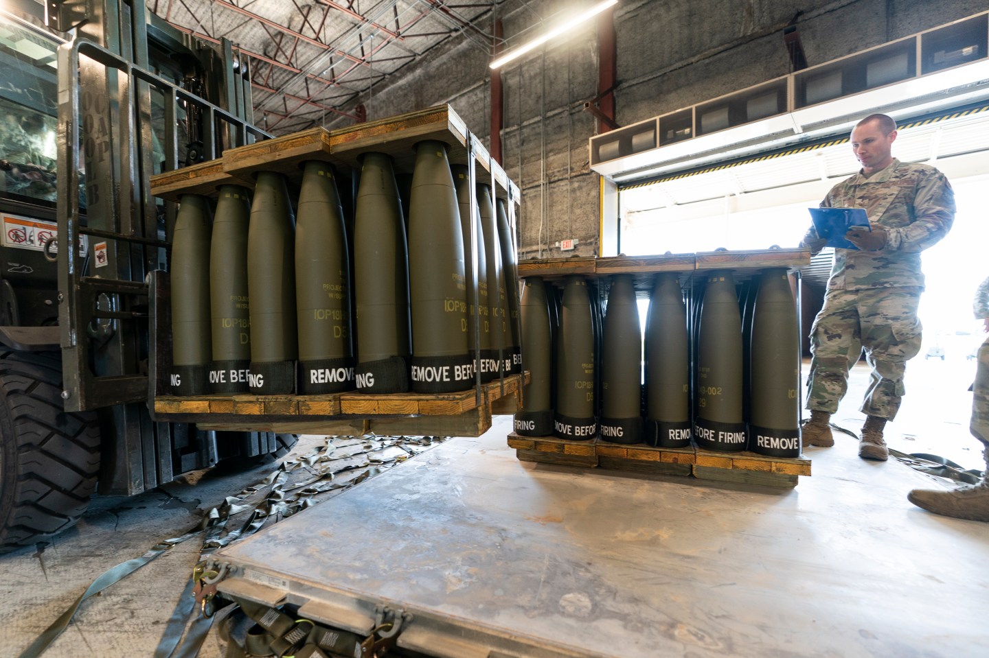 An Air Force staff sergeant checks shells bound for Ukraine.