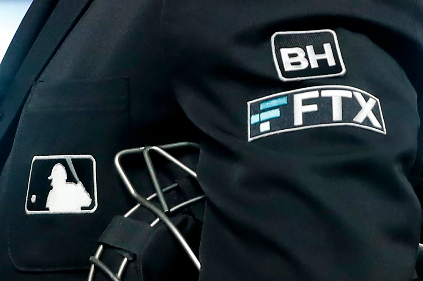 The FTX logo appears on a home plate umpire's jacket at a baseball game with the Minnesota Twins on Sept. 27, 2022, in Minneapolis.