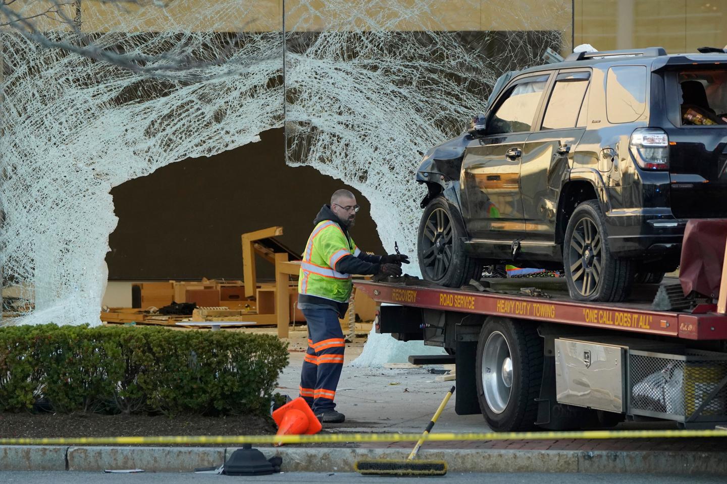 The broken window of an Apple store after a car crashed through it.