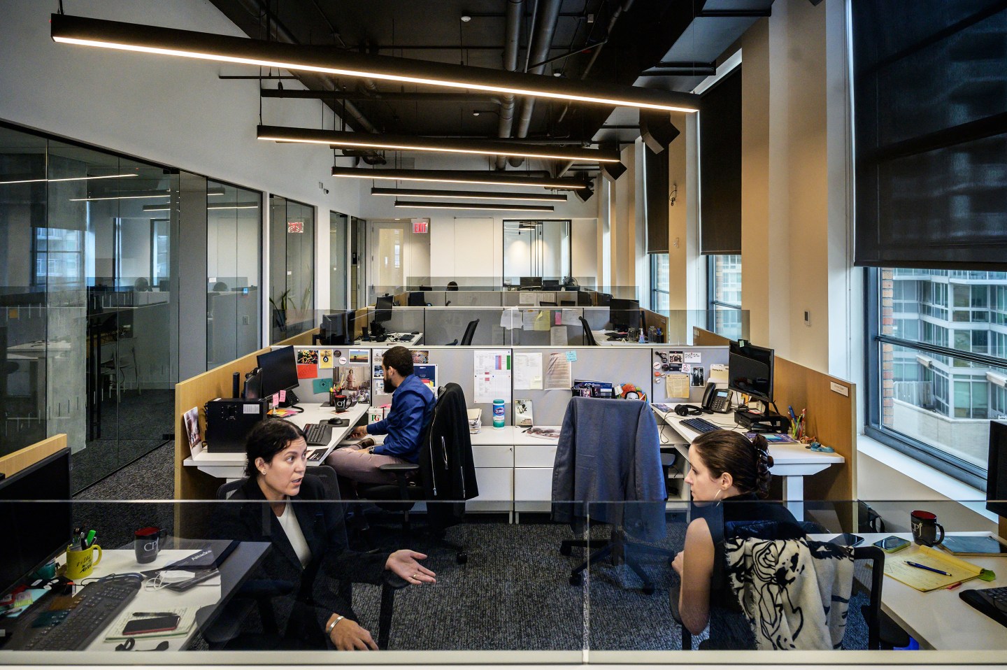 People work in an open office space.