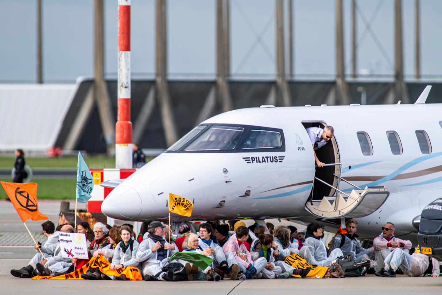 Hundreds of climate activists stormed Amsterdam Schiphol Airport and blocked private jets on the runway