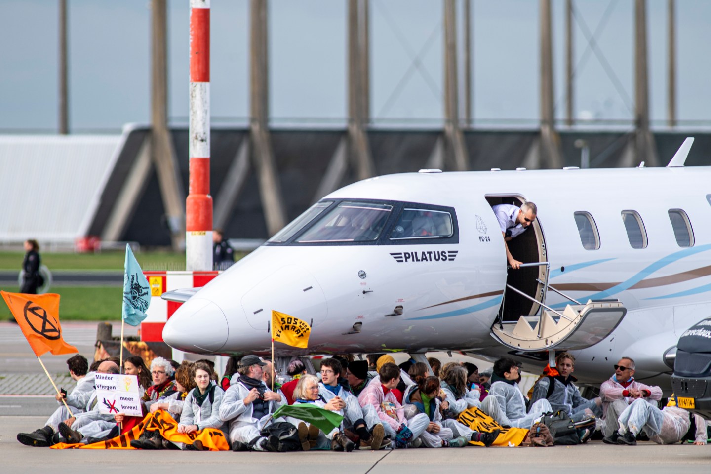 Activists from Extinction Rebellion and Greenpeace Netherlands hold a peaceful protest at Amsterdam Airport Schiphol, the second-biggest in the EU.