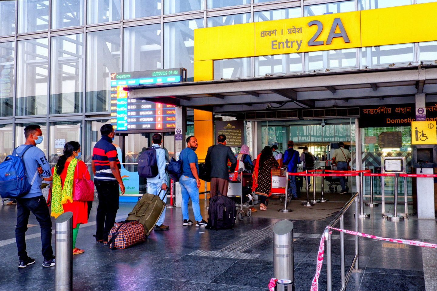 Passengers queue up in front of Kolkata International Airport.
